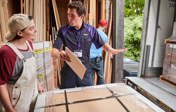 FedEx Freight courier with customer