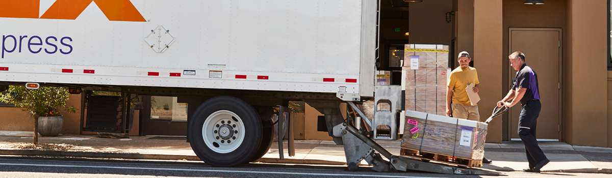 FedEx employee pushing freight