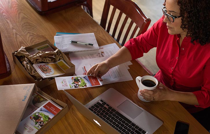 A business owner reviewing brochures