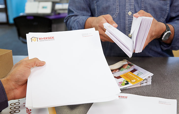 FedEx Employee handing over a stack of stationary