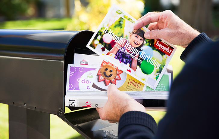 customer looking at postcard