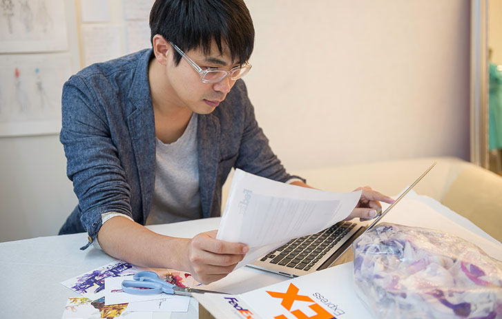 man on laptop reviewing document