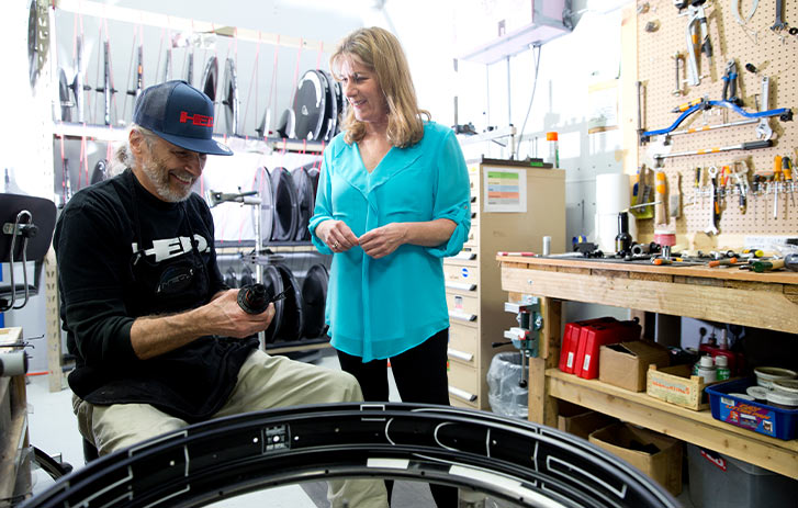 A photo of Anne Hed and another employee from Hed Cycling in a workshop