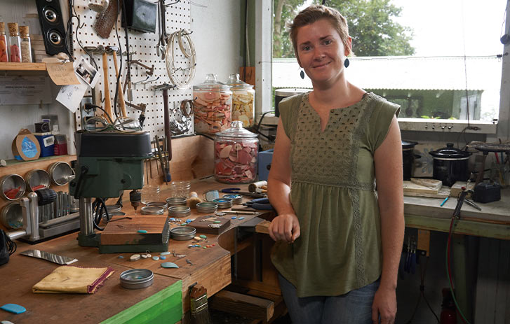 A photo of Kat Crabill, founder of Nurdle in the Rough, in her jewelry workshop