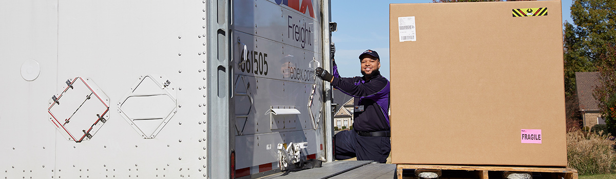 FedEx team member unloading a freight truck.