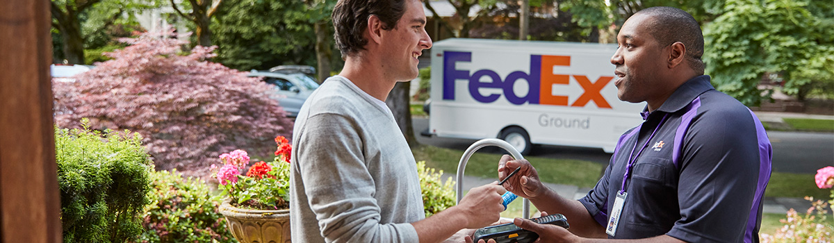 A FedEx team member dropping off a package.