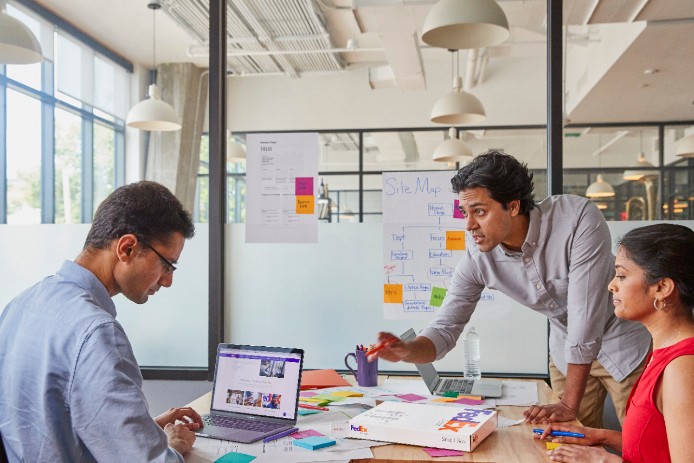 Three people interacting in business meeting. 