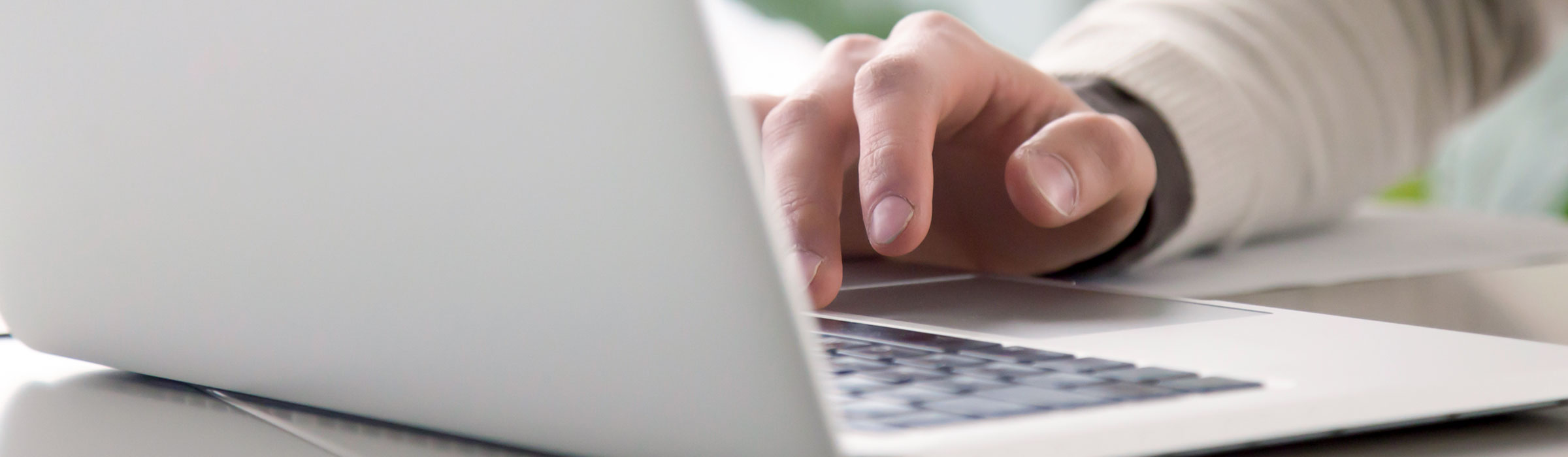 Laptop on table with hand