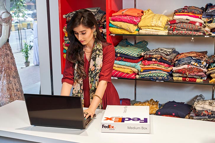 woman on laptop in clothing store