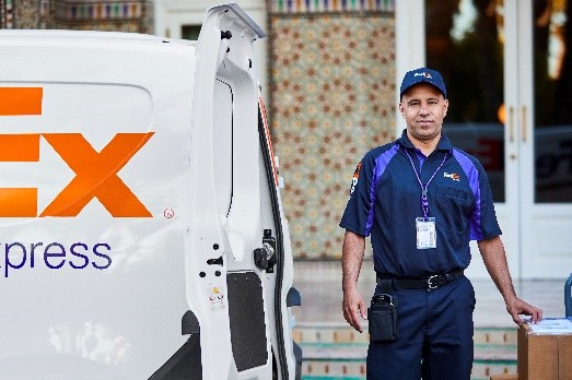 FedEx driver delivering a shipment to an overseas location.