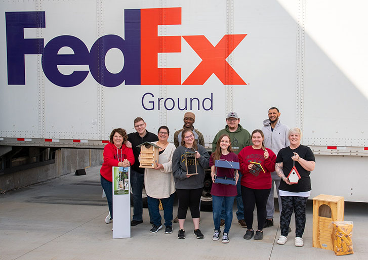 JCs Wildlife employee's standing in front of a FedEx truck