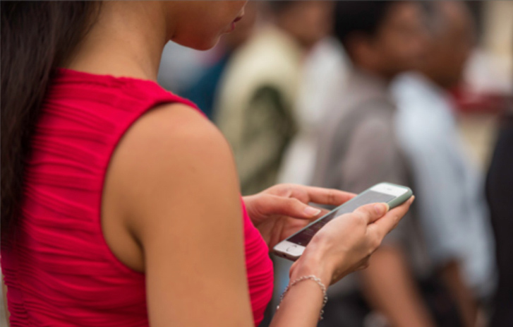 A woman looking at a cell phone