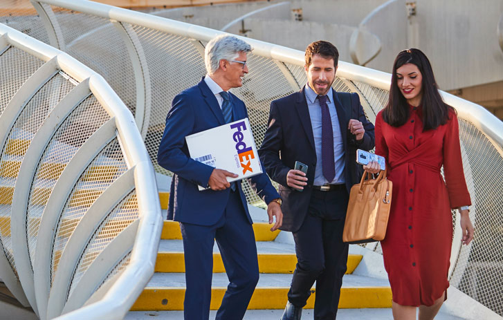 three people walking down stairs