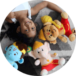 A young girl laying on the carpet along with three stuff toys