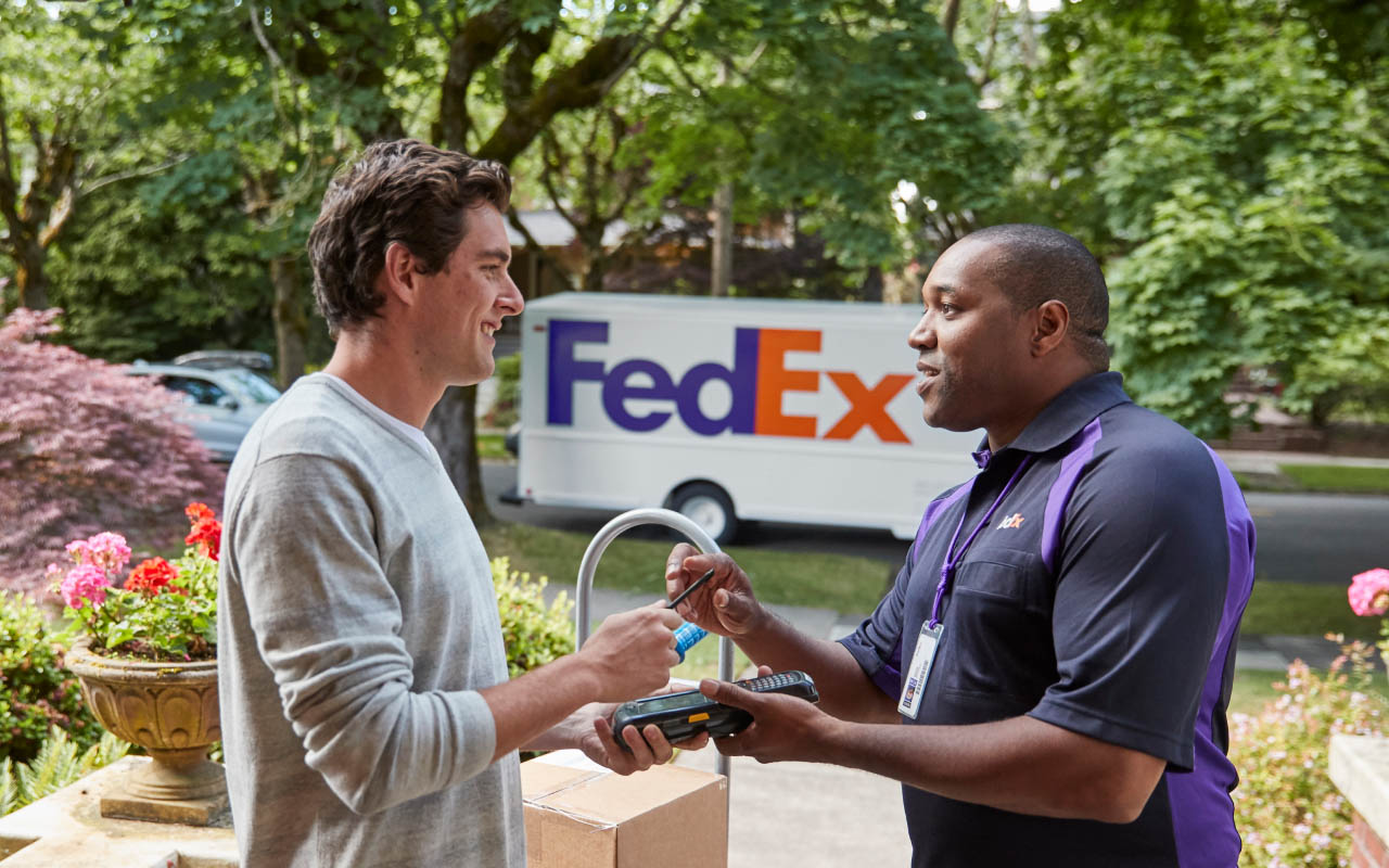 A FedEx team member dropping off a package.