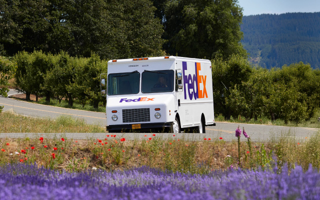 A FedEx truck driving down the road.