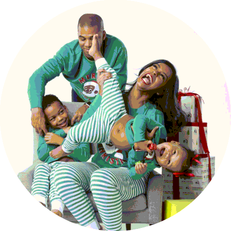 A family of four wearing matching green outfits as they play