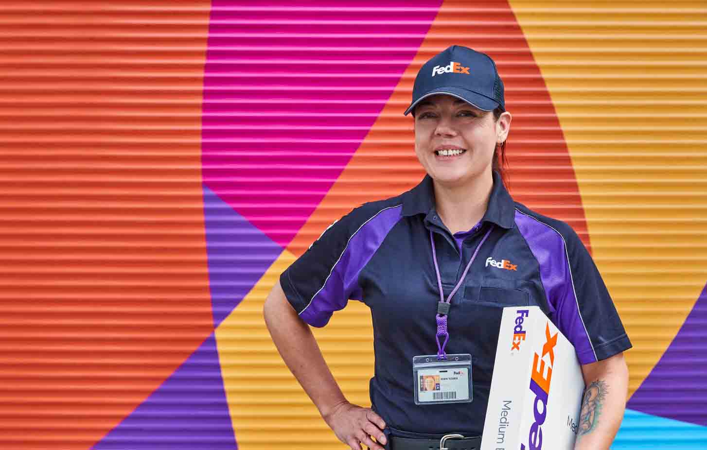 A FedEx team member holding a package.