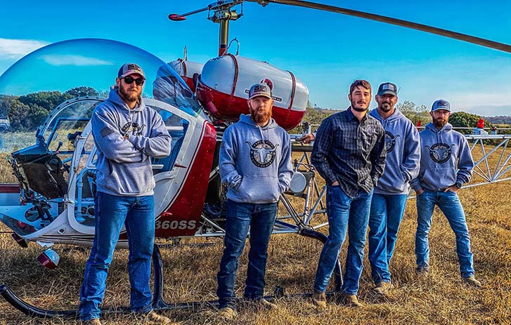 KC Cattle Company team standing in front of helicopter